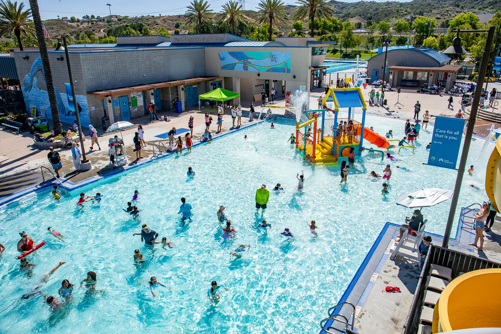 Children playing in pool with slide and activities