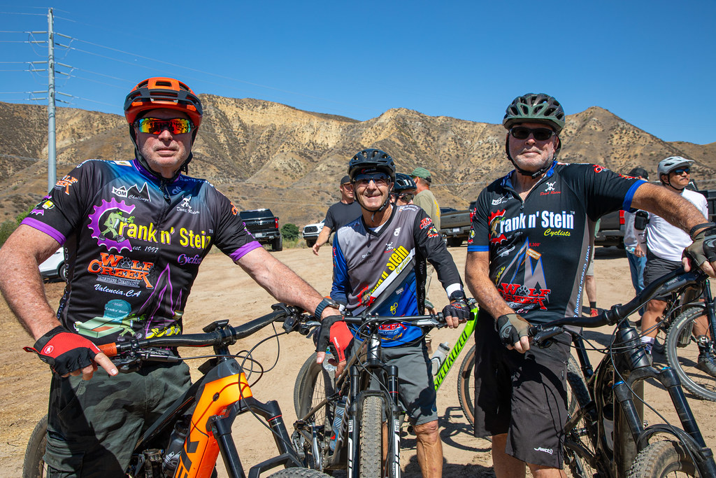 Men posed on mountain bikes